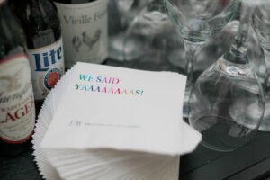 white cocktail napkins with "we said yaaaaaas" in all capitol letters and rainbox ombre text.