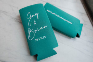 teal tall drink coozies that say "Brian & Jay" in cursive