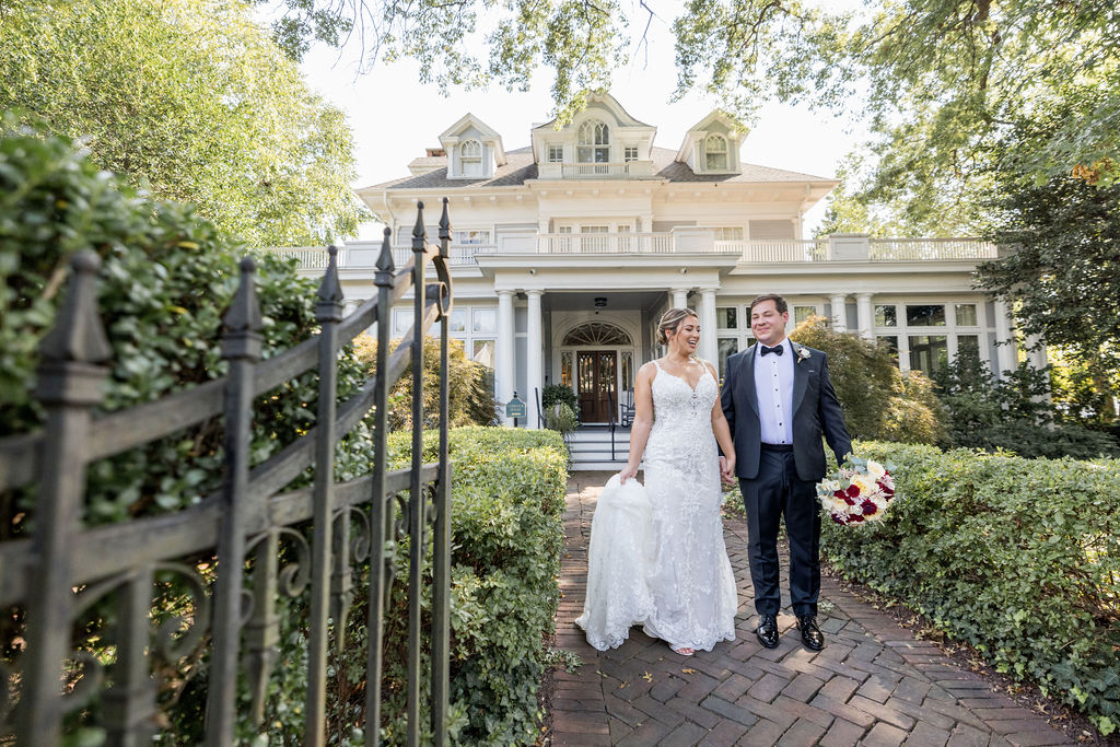 Bride and Groom holding hands while standing in front of the Tide Water Inn Wedding Venue, located on the eastern shore of Maryland.